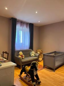 a living room with a dog in the middle of the room at Corps de ferme à 50min de Lyon in Moissieu-sur-Dolon +8 photos