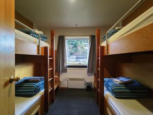 a room with two bunk beds and a window at Zula Lodge in Wanaka