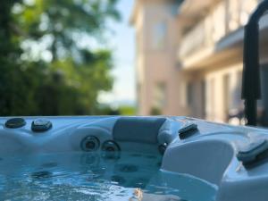 a blue pool of water with a building in the background at Angele Pihenőház in Balatonszárszó