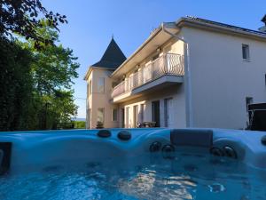 a house and a swimming pool in front of a house at Angele Pihenőház in Balatonszárszó