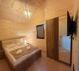 a bedroom with a bed in a wooden cabin at Cottage Ametapi in Mestia
