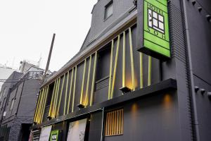 a building with yellow lines on the side of it at HOTEL 壮-soh-shibuya in Tokyo