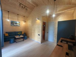 a living room with a blue couch and a table at Cottage Ametapi in Mestia