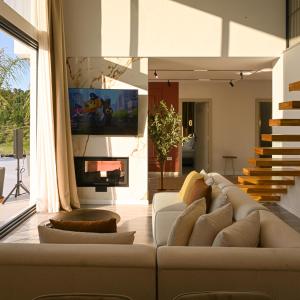 a living room with a couch and a tv at Villa 30 Luxury Place Vlore in Fshati i Ri