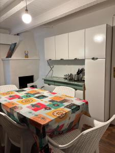a kitchen with a table and chairs and a refrigerator at Casa Felice in Senigallia
