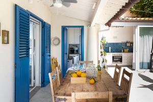 a wooden table with fruit on it in a kitchen at Casa Mamà private access to sea in Santa Flavia +46 photos