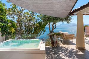 a swimming pool with a view of the water at Casa Mamà private access to sea in Santa Flavia