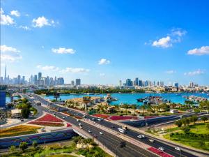 a highway in a city next to a body of water at Tulip Creek Hotel Apartments in Dubai