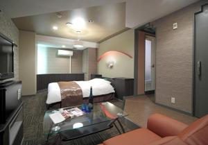 a hotel room with a bed and a glass table at HOTEL K's L Adult only in Urigōchō +22 photos