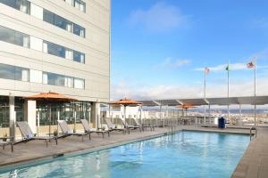 a hotel pool with chairs and a building at Marriott Tacoma Downtown in Tacoma