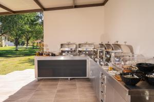 a kitchen with a counter with several pots and pans at Chrissi Ammoudia in Toroni