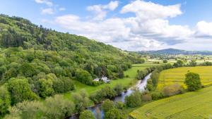 an aerial view of a river in a valley at Charming 3-Bed Cottage by the River Usk in Abergavenny
