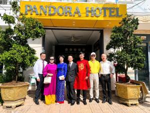 a group of people standing in front of a pomo hotel at Pandora Hotel Cần Thơ in Can Tho