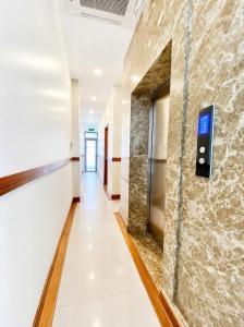 a hallway in a building with a sign on a wall at Pandora Hotel Cần Thơ in Can Tho