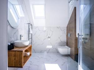 a bathroom with a sink and a toilet at Hellene Snow Starý Smokovec in Starý Smokovec +120 photos
