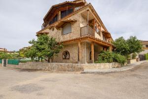 an old house with a balcony on a street at Ca la Crish in Horta de San Joan