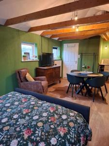 a bedroom with a bed and a tv and a table at Drenthse Klaver in Borger in Borger