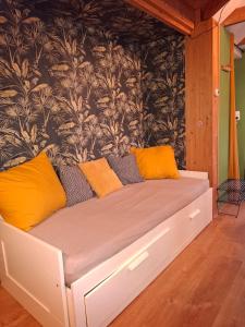 a bed with yellow pillows on it in a room at Drenthse Klaver in Borger in Borger