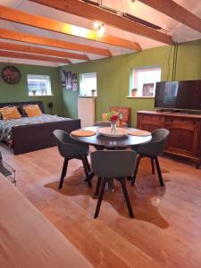 a living room with a table and a couch at Drenthse Klaver in Borger in Borger