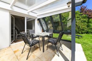 a patio with a table and chairs on it at Ferienhaus Windspiel in Neuharlingersiel