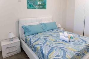 a bedroom with a bed with a teddy bear on it at Casa Turchese in Alghero