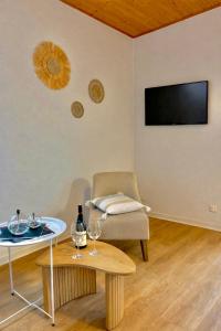 a living room with a table and a chair at Camping maeva Escapades Domaine de la Vingeanne in Longeau