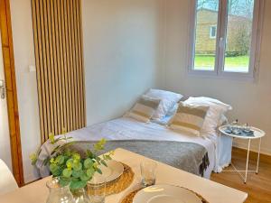 a small room with a bed and a table at Camping maeva Escapades Domaine de la Vingeanne in Longeau +43 photos