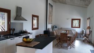 a kitchen and living room with a table and chairs at Sa Talaia in Lluc