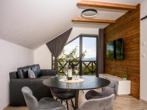 a living room with a table and a couch at Hellene Snow Starý Smokovec in Starý Smokovec