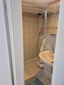 a small bathroom with a tub and a sink at Ferienwohnung Weitblick in Steinbach im Taunus