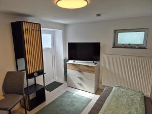 a small living room with a tv and a couch at Ferienwohnung Weitblick in Steinbach im Taunus