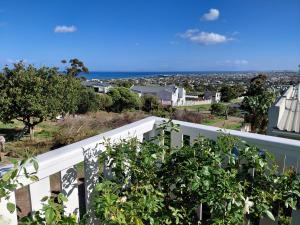 a balcony with a view of a city at Martha's Place in Gordonʼs Bay