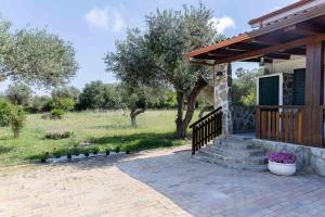 a house with a porch and stairs to a yard at Casa Turchese in Alghero