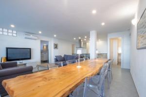 a large wooden table in a living room with chairs at Residence Sole Dell'Argentario in Porto Santo Stefano