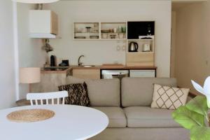 a living room with a couch and a table at RCE Albufeira Spring, Summer & Fall in Albufeira