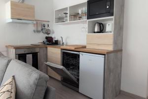 a kitchen with a stove and a dishwasher at RCE Albufeira Spring, Summer & Fall in Albufeira