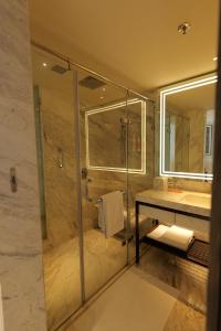 a bathroom with a shower and a sink at Le Meridien Amritsar in Amritsar