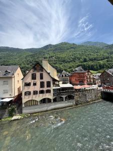 a town next to a body of water at Hotel Europa Les by Dynamic Hotels in Les