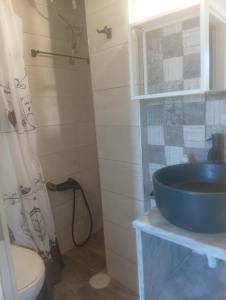 a bathroom with a blue sink and a toilet at Evriaki Rooms Lesvos in Apidias Lakos