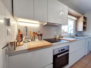 a kitchen with white cabinets and a counter top at Playa de Baria I in Vera