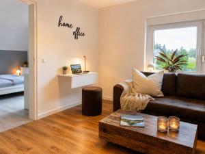 a living room with a couch and a table at Ferienwohnung Penny-Ranch in Zethau +21 photos