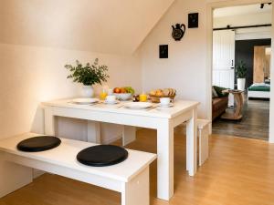 a living room with a white table with fruits on it at Ferienwohnung Penny-Ranch in Zethau