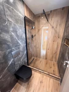 a bathroom with a shower with a toilet in it at Hotel Il Cavallino in Warendorf +60 photos
