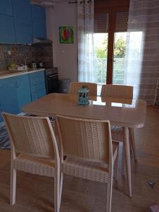 a table and chairs in a kitchen with a table and chairsktop at Evriaki Rooms Lesvos in Apidias Lakos