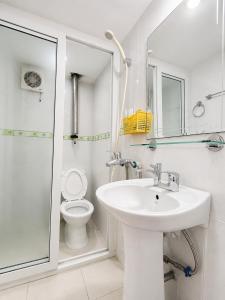a white bathroom with a sink and a toilet at Hisun Hotel Quốc tế - Đông Anh in Thụy Ha +15 photos