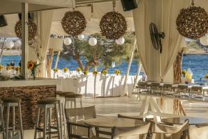 a restaurant with tables and chairs and a view of the water at Santana Beach in Agia Anna Naxos