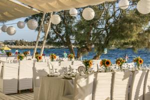 a table set up for a wedding by the water at Santana Beach in Agia Anna Naxos