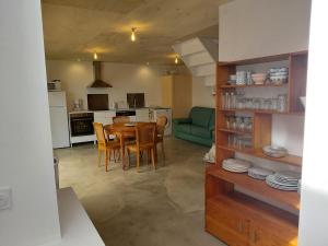 a kitchen and dining room with a table and chairs at Penty vue sur mer in Tréguennec