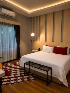 a bedroom with a large white bed with red pillows at Villa Escape Aonang Krabi in Krabi +32 photos