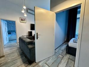 a living room with a couch and a sliding door at Royal City Centre Apartment - 2 Bedrooms 72 m2 - AC - Balcony - Coffee Machine - Washer - Dryer -Parking available Free public or Paid Private for 20 euro per stay Please read our emails in Poprad +32 photos